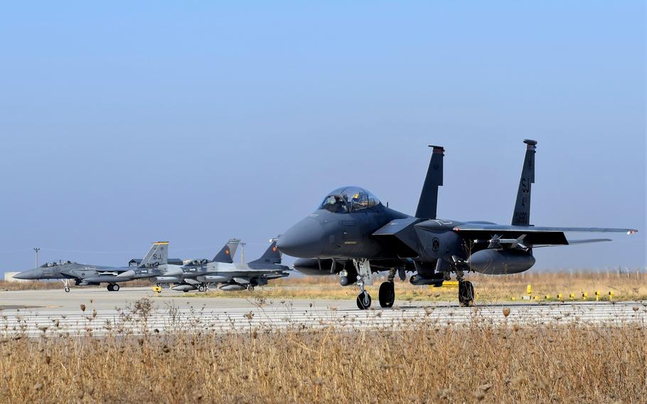 U.S. F-15E Strike Eagles from Seymour Johnson Air Force Base in North Carolina taxi alongside Romanian F-16 Fighting Falcon aircraft during training at Borcea Air Base, Romania, in October 2021. An F-16 training center will be set up at the air base and could eventually host Ukrainian trainees.