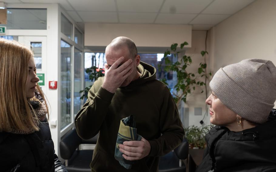 A freed Ukrainian prisoner of war and the wives of fellow soldiers who are still detained, on Tuesday. 