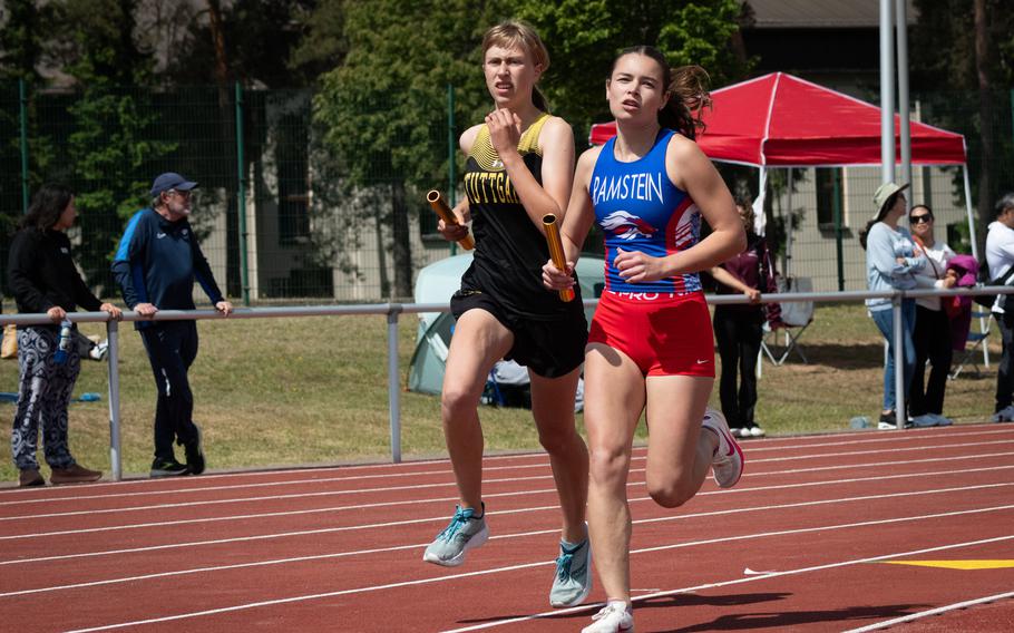 Stuttgart’s Anna Konon and Ramstein’s Iliana Echard battle for the lead during the second leg of the girls’ 3,200-meter relay at the DODEA Europe track and field championships on Thursday, May 22, 2025, in Kaiserslautern, Germany. Stuttgart went on to the win the event in 9:57.91, about three seconds faster than Ramstein. Kendall Cancel, Pasha Miletich and Lydia Pound were the other runners for Stuttgart.