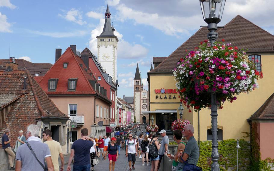 In the afternoon, many enjoy a glass of wine on the Alte Mainbruecke, the old stone bridge spanning the Main River at Wuerzburg. The city is in the heart of Franconian wine country.