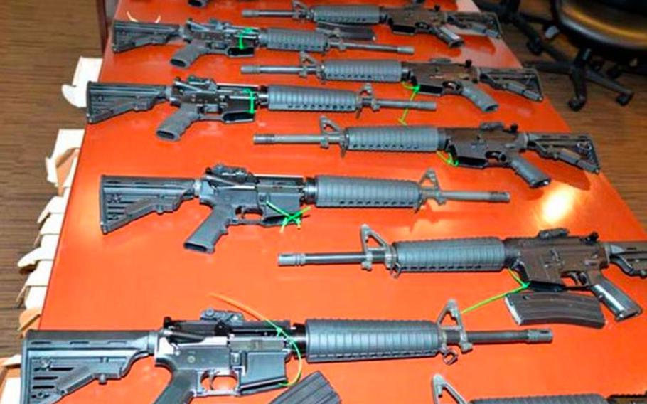 The .223-caliber rifles produced by Mahde and Moyad Dannon in Indiana are on display by the Justice Department in Indiana. Among these are six fully-automatic firearms, which were prepared for shipment to the Middle East to assist ISIS, the Justice Department said.