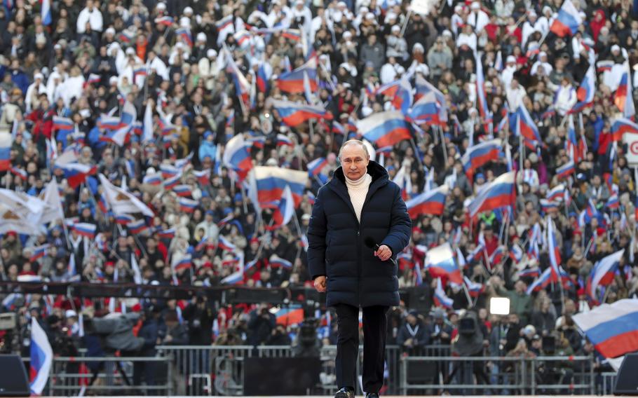 Russian President Vladimir Putin arrives to deliver his speech at the concert marking the eighth anniversary of the referendum on the state status of Crimea and Sevastopol and its reunification with Russia, in Moscow, Russia, Friday, March 18, 2022. (Mikhail Klimentyev, Sputnik, Kremlin Pool Photo via AP)