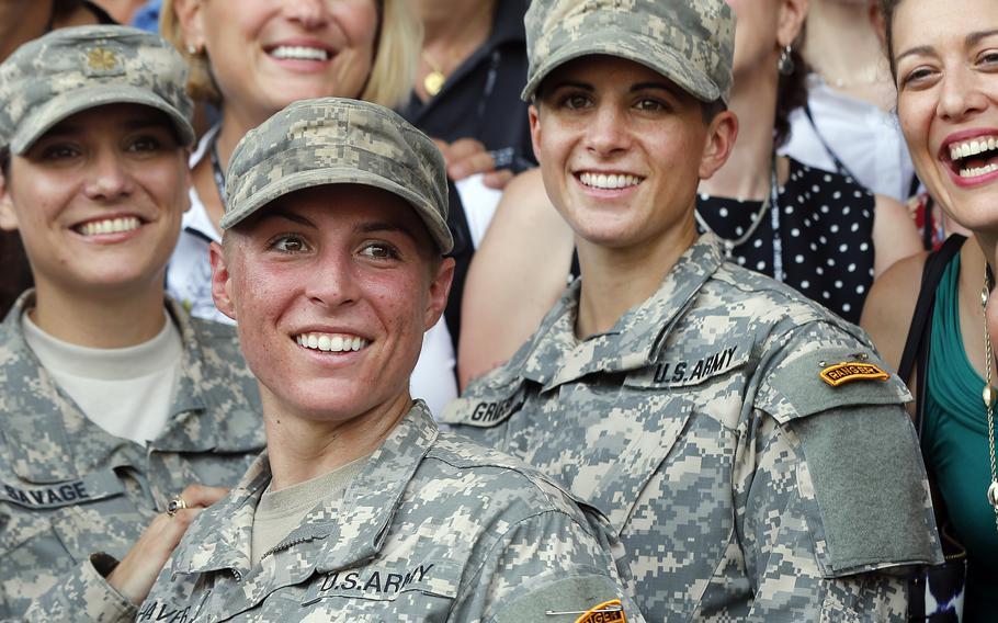 Army 1st Lt. Shaye Haver, center, and Capt. Kristen Griest, right, pose for photos with other female West Point alumni after an Army Ranger school graduation ceremony at Fort Benning, Ga., on Aug. 21, 2015.