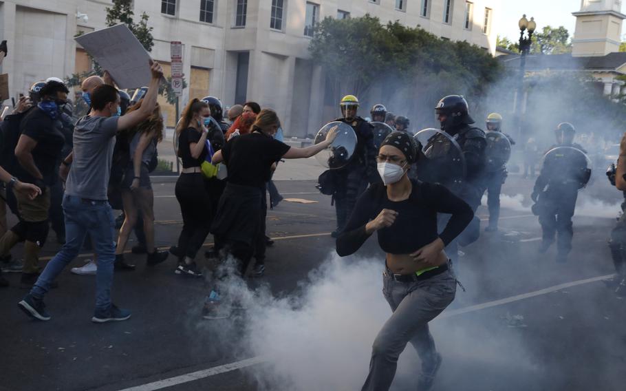 Demonstrators move away from police near Lafayette Square on June 1, 2020.