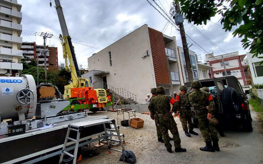 Japanese military remove a U.S.-made shell at a construction site in Okinawa, Japan.