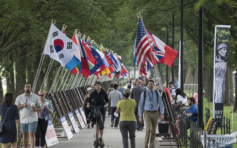 The flags of 67 countries that allied themselves to the Republic of Korea during the Korean War fly just outside the Korean War Memorial on the National Mall in Washington, D.C. on Wednesday, July 27, 2022, during a ceremony to dedicate the memorial's Wall of Remembrance addition.