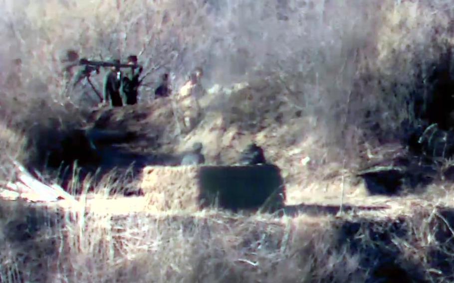 North Korean soldiers with weapons are seen in a trench inside the Demilitarized Zone in this undated photo provided by South Korea’s Ministry of National Defense on Nov. 27, 2023.