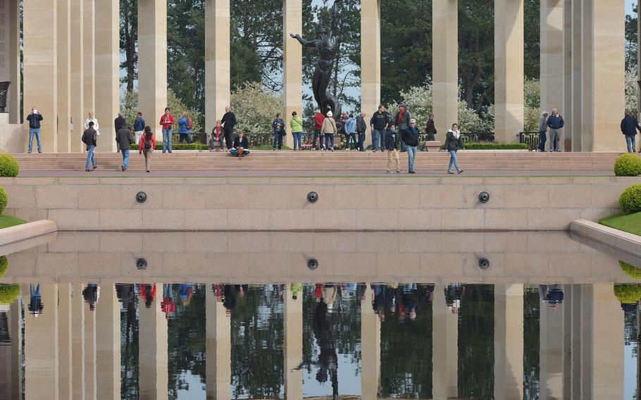 The 22-foot statue “The Spirit of American Youth Rising from the Waves” is reflected in the pool at Normandy American Cemetery at Colleville-sur-Mer, France.