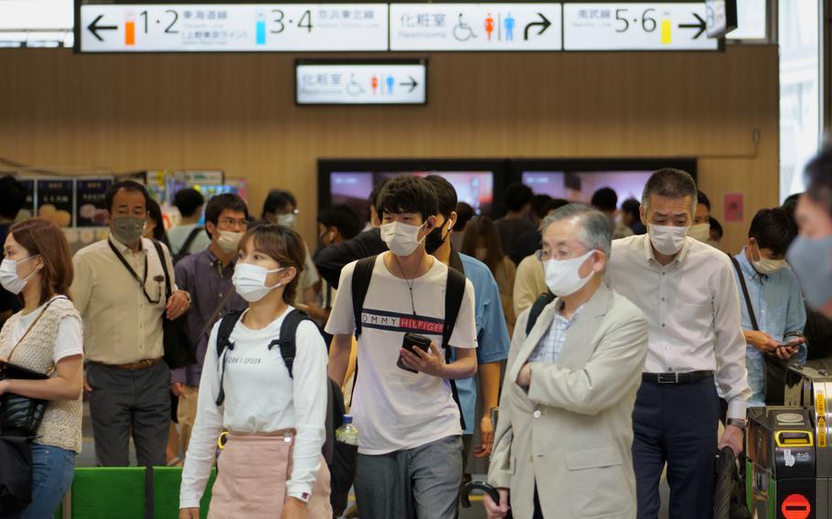 Residents of Kawasaki, Japan, uniformly wear masks to prevent the spread of coronavirus on the city streets Aug. 17, 2021. 