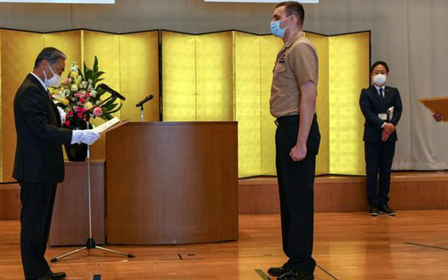 Petty Officer 2nd Class Ryan Sorrem of Naval Air Facility Misawa receives a certificate of commendation from Oirase Mayor Takashi Narita, March 1, 2023. 