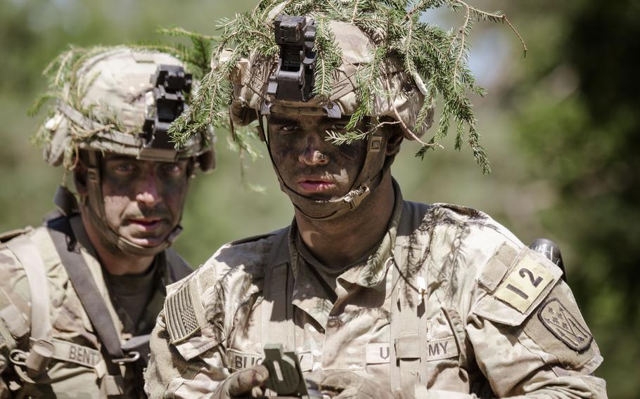 An Army soldier directs his squad