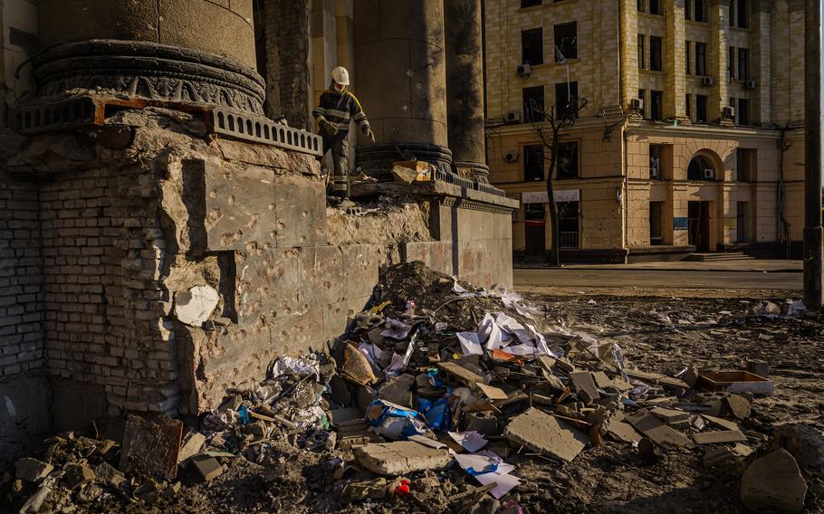 Firefighters clean up debris inside the Kharkiv Regional Administration building after it was destroyed by Russian bombardments, in Kharkiv, Ukraine, on March 25, 2022.