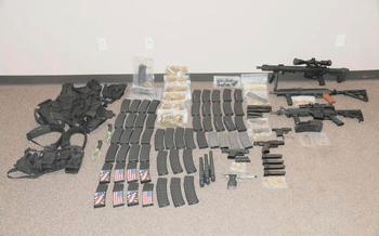 Weapons and ammunition lay on the ground in this police evidence photo.