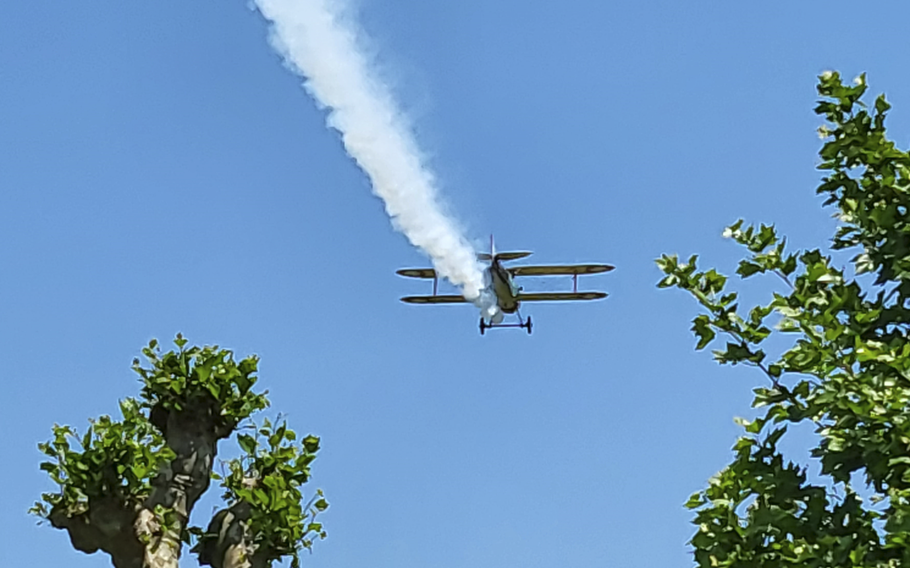 A World War I-era plane performs a flyover at the conclusion of the reinterment ceremony at Oise-Aisne American Cemetery in Seringes-et-Nesles, France, on Wednesday, June 7, 2023. 
