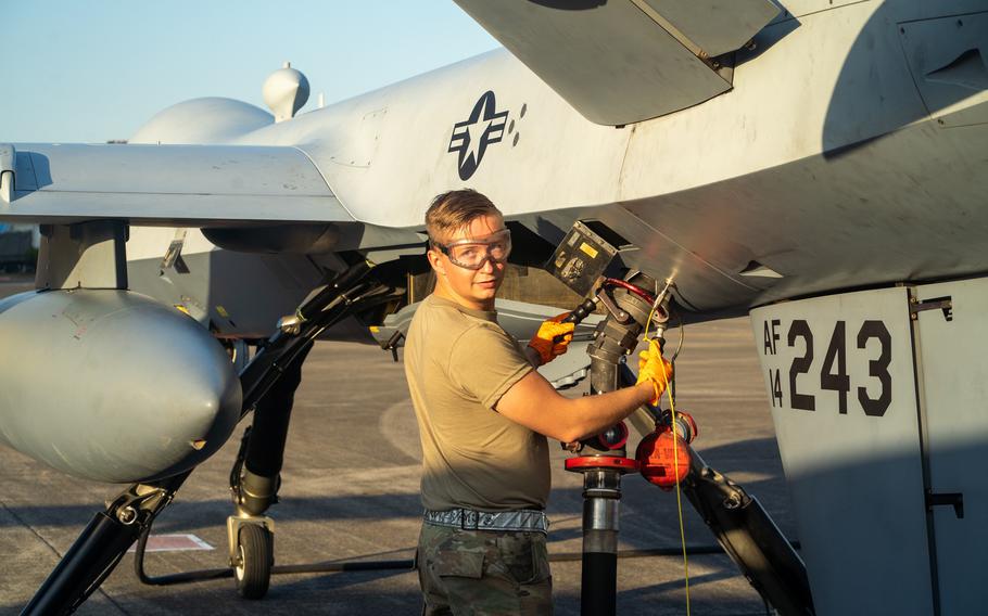 Air Force Airman 1st Class Bradlee Paraska of 319th Expeditionary Reconnaissance Squadron fuels an MQ-9 Reaper drone for a demonstration flight at Kanoya Air Base, Japan, on Nov. 5, 2022.