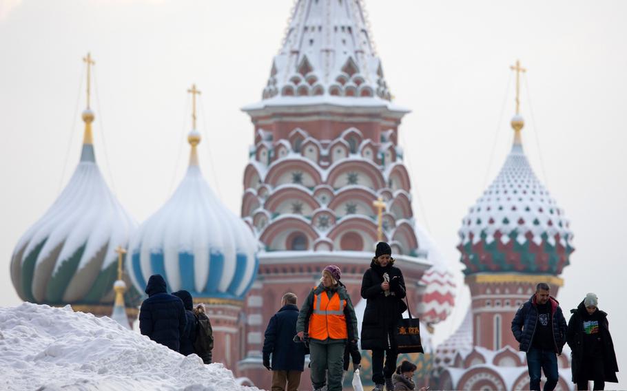 Pedestrians on Red Square by Saint Basil's Cathedral in Moscow on Dec. 14, 2021. 
