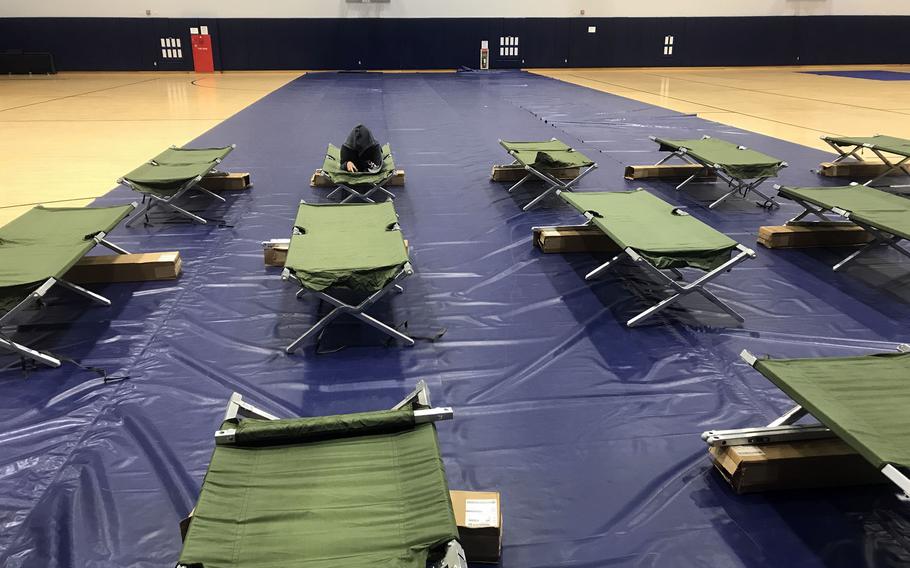 An off-base resident takes shelter from severe tropical storm Nanmadol inside the Ironworks Northside Gym at Marine Corps Air Station Iwakuni, Japan, Monday, Sept. 19, 2022. 