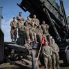 Members of Delta Battery, 5th Battalion, 7th Air Defense Artillery Regiment gather for a photo on a Patriot missile launcher in southeastern Poland on March 7, 2023.