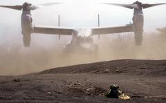 A Marine Corps MV-22 Osprey lands near Mount Fuji while Japan Ground Self-Defense Force soldiers secure the area during training on March 15, 2022.