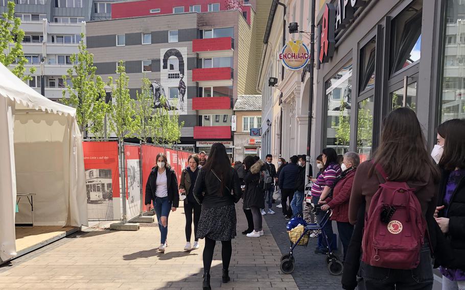 People wait in line for a free coronavirus antigen test in Kaiserslautern, Germany, in May 2021. Although Germany will end free coronavirus testing for residents in October, the U.S. military in the country will continue offering coronavirus tests at no cost to eligible beneficiaries.