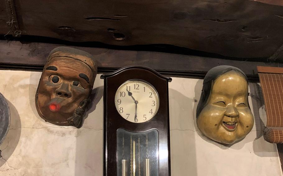 Smoke-weathered masks watch over diners at Sanrokuen, a robatayaki restaurant near Mount Fuji. 