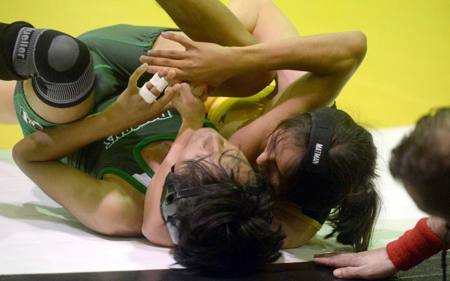 Kadena's Mizuki Sato-Marsh locks in a cradle hold on Kubasaki's Jesse Fuentes at 101 pounds during Wednesday's Okinawa wrestling dual meet. Sato-Marsh won by technical fall 11-0 in 1 minute, 46 seconds.