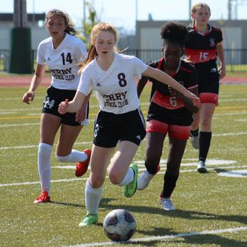 Matthew C. Perry’s McKenzie Mitchell dribbles upfield against E.J. King during Saturday’s DODEA-Japan soccer match. The teams battled to a scoreless draw, the Samurai’s eighth of the season and the Cobras’ ninth.