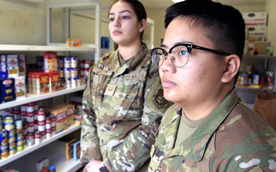 Senior Airman Armanda Jackson, left, and Senior Airman Christina Pruch stand inside their food pantry at Kadena Air Base, Okinawa, March 3, 2023.