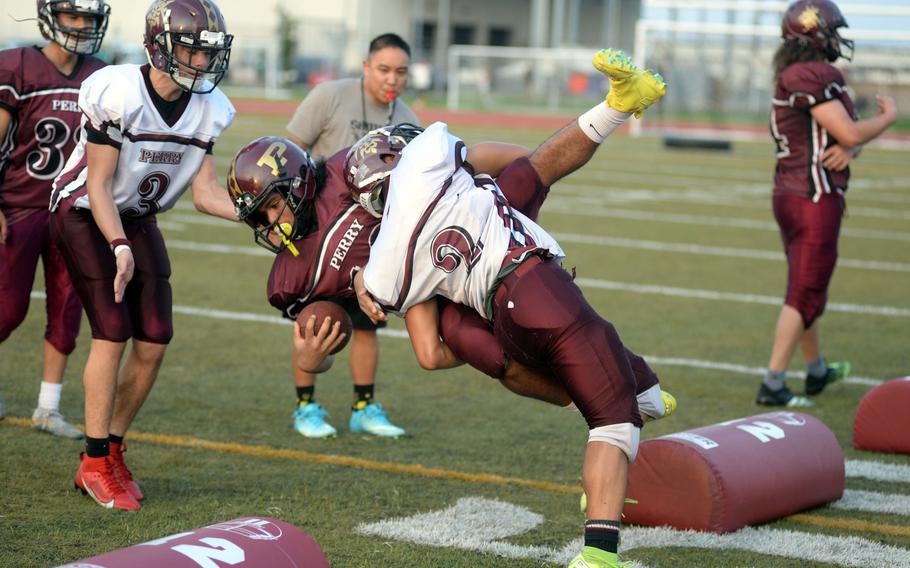 Ethan Mercado tackles in practice.