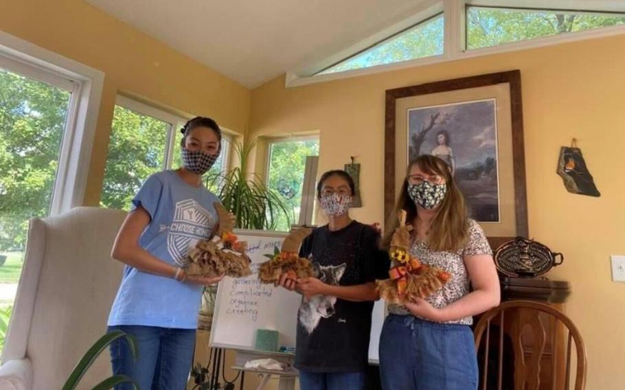 Members of the Wright-Patterson International Spouses Group make crafts for a fall fair in 2021. 