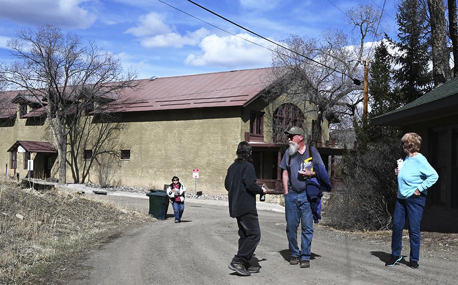 Dorthy Vigil, left, hustles to catch up with her neighbors after they attended a town hall meeting on March 20, 2023, in Cokedale, Colorado. Vigil has lived in Cokedale for 52 years. 