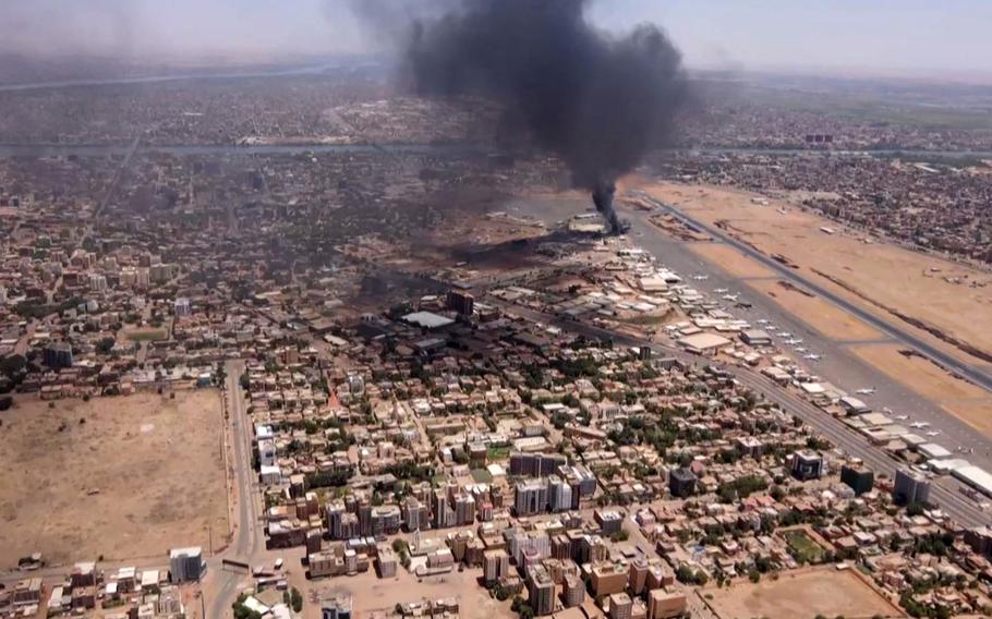 This image grab taken from AFPTV video footage on April 20, 2023, shows an aerial view of black smoke rising above the Khartoum International Airport amid ongoing battles between the forces of two rival generals. 