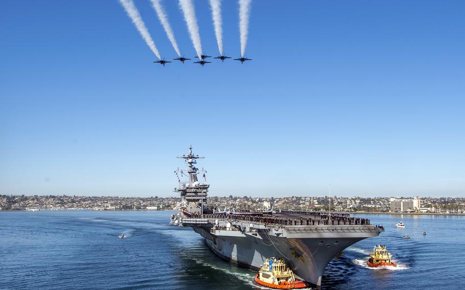 The U.S. Navy's Blue Angels fly in formation over the aircraft carrier USS Carl Vinson as it returns to San Diego on Monday, Feb. 14, 2022, after eight months at sea.