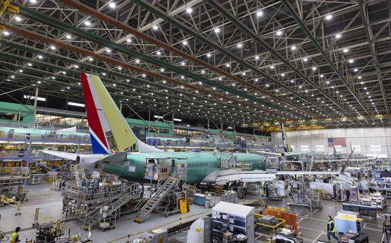 Boeing employees work on the 737 MAX on the final assembly line at Boeing's Renton plant, June 15, 2022 in Renton, Wash. The SEC announced Thursday, Sept. 22, 2022, that Boeing Co. will pay $200 million to settle allegations that the company and its former CEO misled investors about the safety of its 737 Max after two of the airliners crashed, killing 346 people.