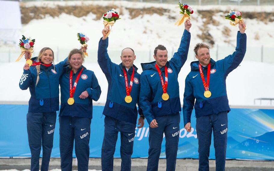 Team USA cross-country skiers, from left, Oksana Masters, Sydney Peterson, Dan Cnossen, Jake Adicoff and guide Sam Wood celebrate a gold medal in the mixed 4x2.5km relay, Sunday, March 13, 2022, the final day of the Beijing Paralympics. 