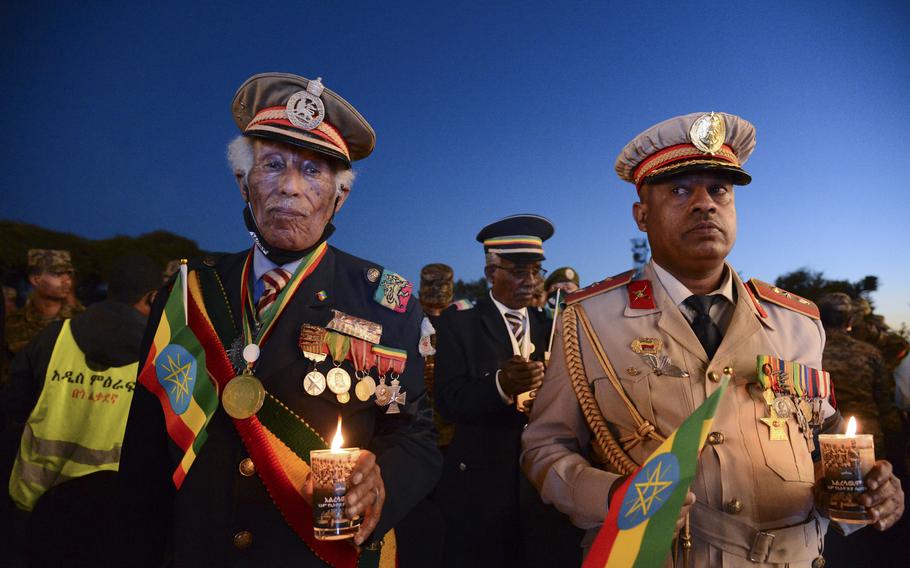 Current and former Ethiopian military personnel and the public commemorate federal soldiers killed by forces loyal to the Tigray People’s Liberation Front (TPLF) at the start of the conflict one year ago, at a candlelit event outside the city administration in Addis Ababa, Ethiopia Wednesday, Nov. 3, 2021. All sides in Ethiopia’s yearlong war in the Tigray region have committed abuses marked by “extreme brutality” that could amount to war crimes and crimes against humanity, the U.N. human rights chief said Wednesday. 
