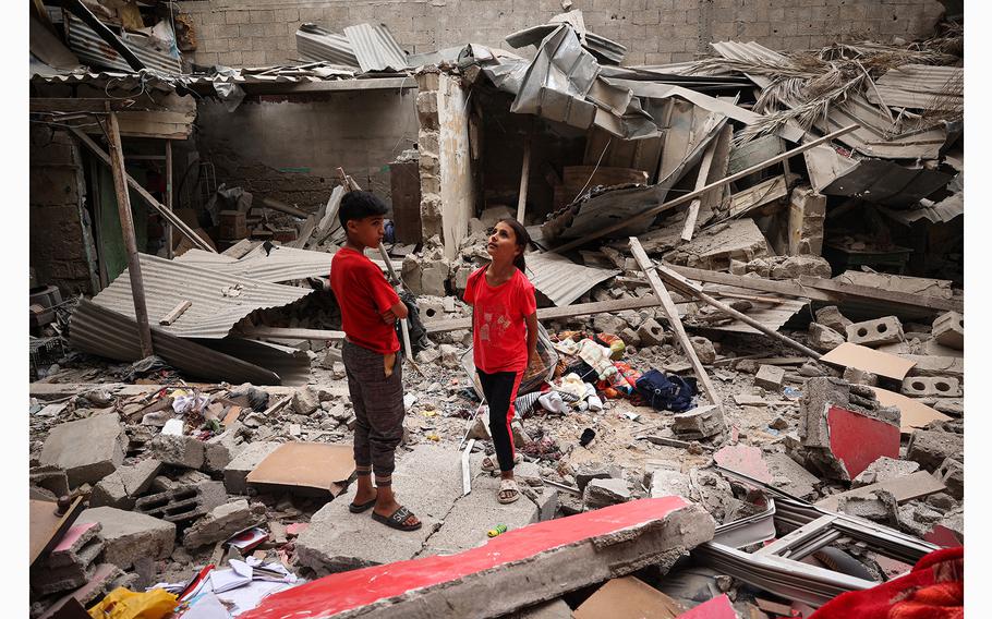 Palestinian children stand amid the debris of a house destroyed by overnight Israeli bombardment in Rafah in the southern Gaza Strip on Saturday, April 27, 2024, as the conflict between Israel and the militant group Hamas continues. 