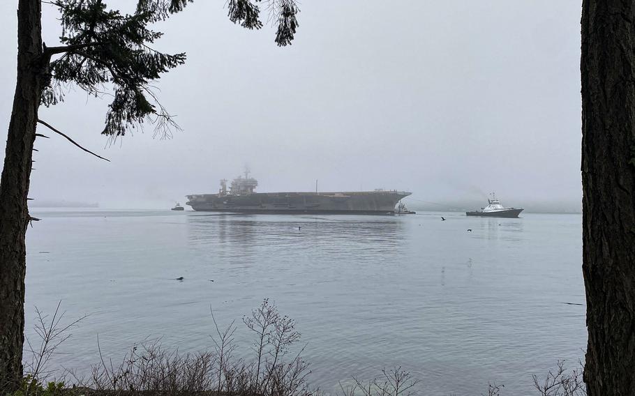 Navy tug boats support the decommissioned USS Kitty Hawk as it departs Naval Base Kitsap in Bremerton, Wash., Jan. 15, 2022. The carrier is bound for a shipbreaking facility in Brownsville, Texas.