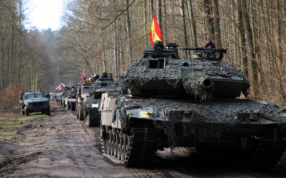 NATO forces including Spanish, Polish, French and American tanks, as well as other military vehicles from Turkey and Slovakia, line up before boarding amphibious rigs to cross the Vistula River during an exercise near Gniew, Poland, March 4, 2024. 