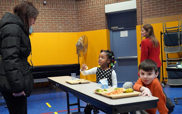 Rachel Jacobson, then-assistant secretary of the Army for installations, energy and environment, talks about school lunch with one of the students at Ansbach Elementary School in Katterbach, Germany, on Feb. 21, 2024. Elevated levels of lead were recently discovered in the water at four sinks at the school.