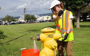 A contractor opens a fire hydrant to collect samples as part of the Navy's drinking water monitoring program at Joint Base Pearl Harbor-Hickam, Hawaii, Jan. 31, 2024.