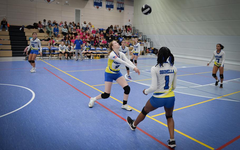 Sigonella’s Emese Hriczu sets the ball as Rickalia Goss gets ready to spike it across to Ansbach during the 2022 DODEA-Europe Volleyball Tournament Oct. 29, 2022, at Ramstein Air Base, Germany.