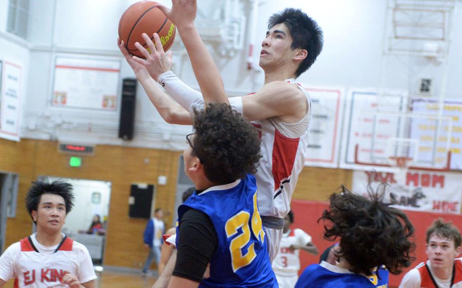 E.J. King's Nolan FitzGerald skies for a shot against Yokota's defense during Friday's DODEA-Japan boys basketball game. The Panthers won 72-70.
