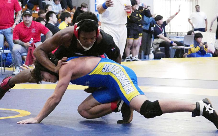 Nile C. Kinnick's Avery Murphy sprawls on Christian Academy Japan's Keiya Nakazawa at 160 pounds during Saturday's CAJ Invitational Tournament.