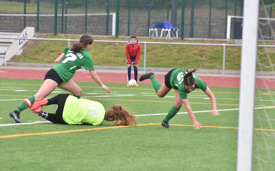 Spangdahlem goalkeeper Isabel Bodily grabs the ball before Alconbury’s Lorna Lee, right, and Eleni Politis tumble over her in the Dragons’ 4-1 victory over the Lions on Tuesday, May 16, 2023, in the DODEA-Europe girls Division III championships at Ramstein Air Base, Germany.