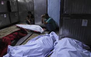 Palestinians mourn their relatives who were killed in an Israeli military strike on Gaza, during their funeral in al-Shifa hospital in Gaza City, Tuesday, June 10, 2025. (AP Photo/Jehad Alshrafi)