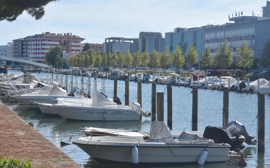 Dozens of boats are parked along a canal that separates much of the residential area of Grado from the city's commercial core. Probably the best places to park for visitors are in diagonal spaces along a small road just to the left of this view.