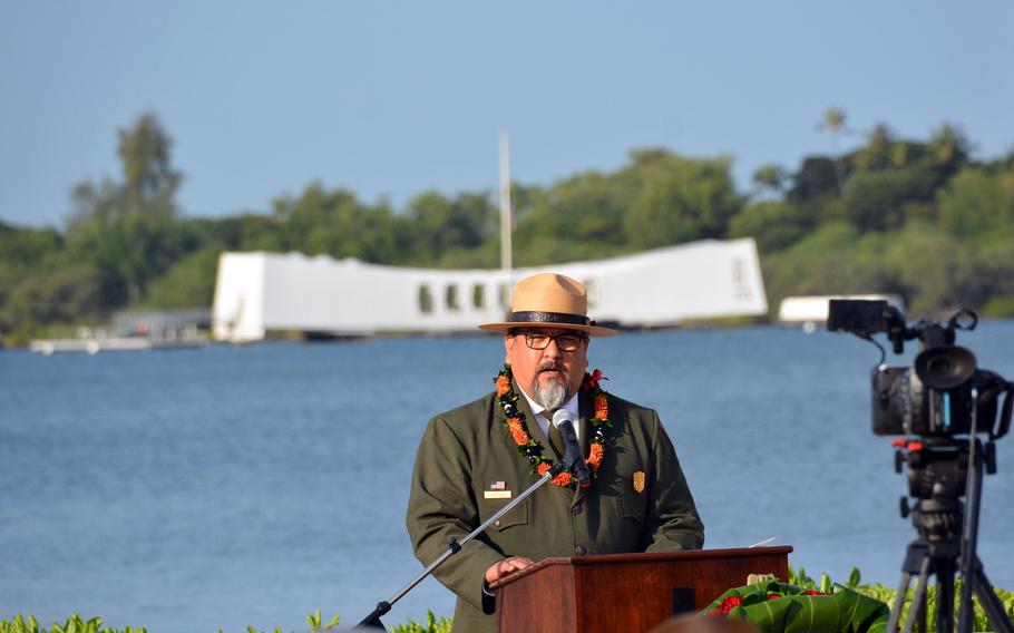 Charles Sams, director of the National Park Service, speaks Dec. 7, 2022, during a ceremony at the Pearl Harbor National Memorial commemorating the 81st anniversary of the attack on Pearl Harbor, with the USS Arizona Memorial behind him.