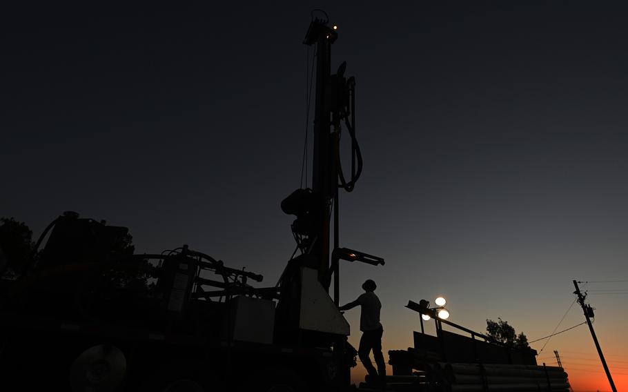An engineer drills a new water well in Fresno, Calif., last August, after a long drought in the region dried up wells.