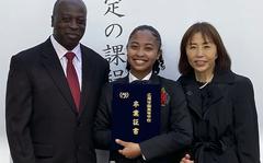 Former Department of Defense Education Activity student Naomi Jack poses with her parents after graduating from Hiroo Gakuen, a college preparatory school in central Tokyo, March 5, 2022.